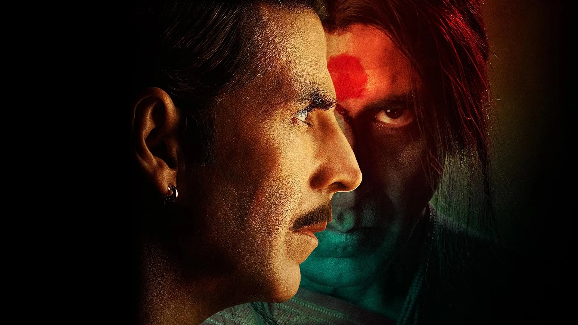 Akshay Kumar as Aasif/Laxmii in a moment of intense transformation or possession, eyes wide with a mix of fear and power.