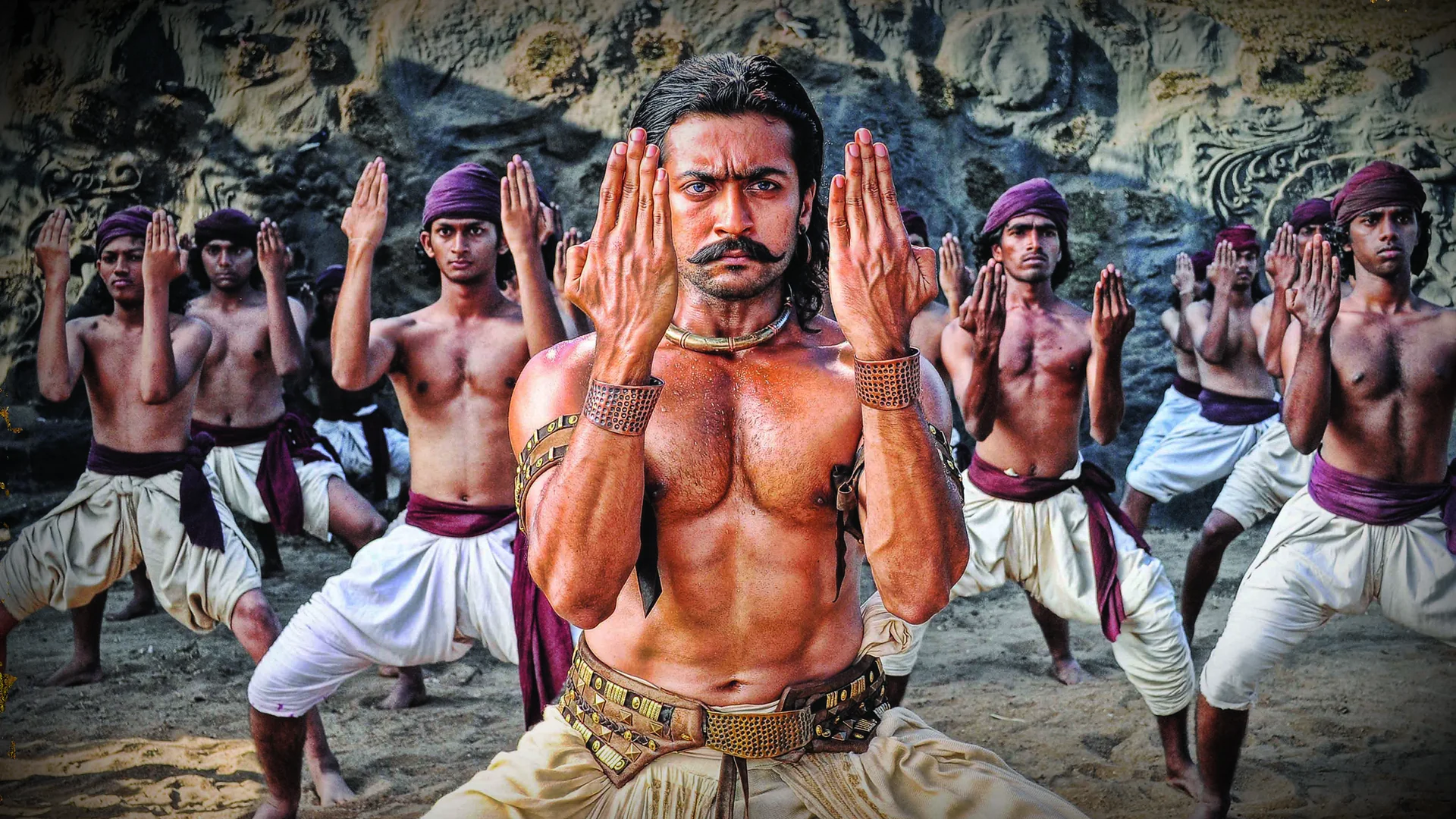 Suriya in a dramatic pose as Bodhidharma, amidst historical settings