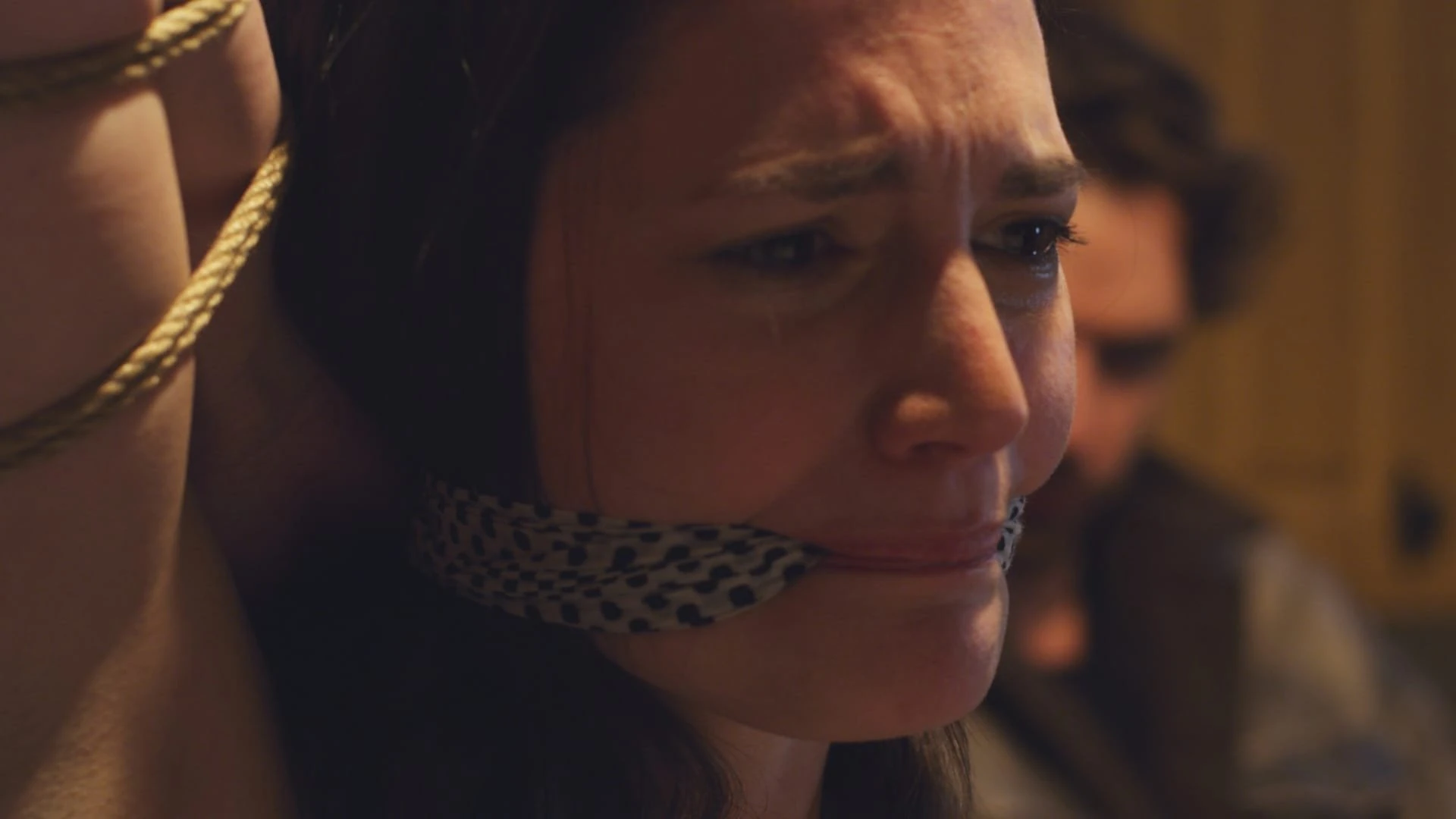 A tense, dimly lit scene from Deadly Virtues, featuring a man and woman in a fraught encounter