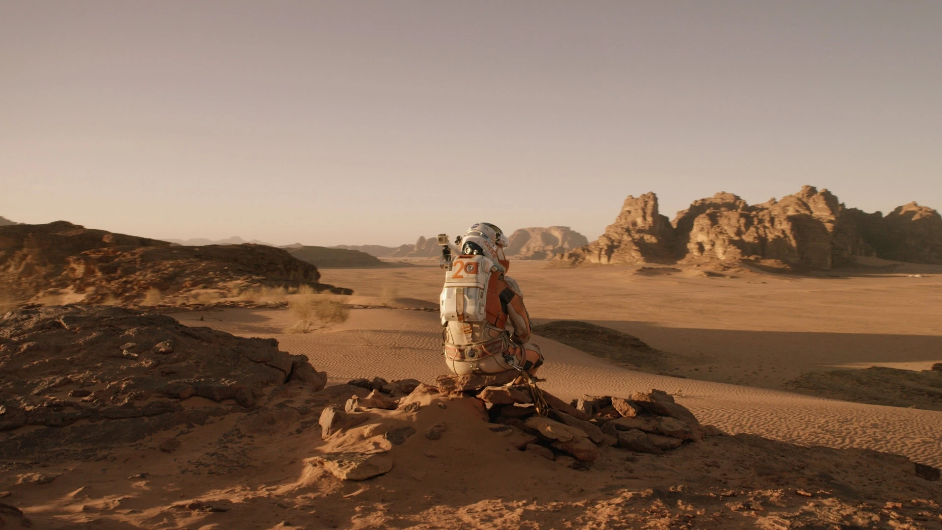 Matt Damon as Mark Watney on the Martian surface, contemplating his survival